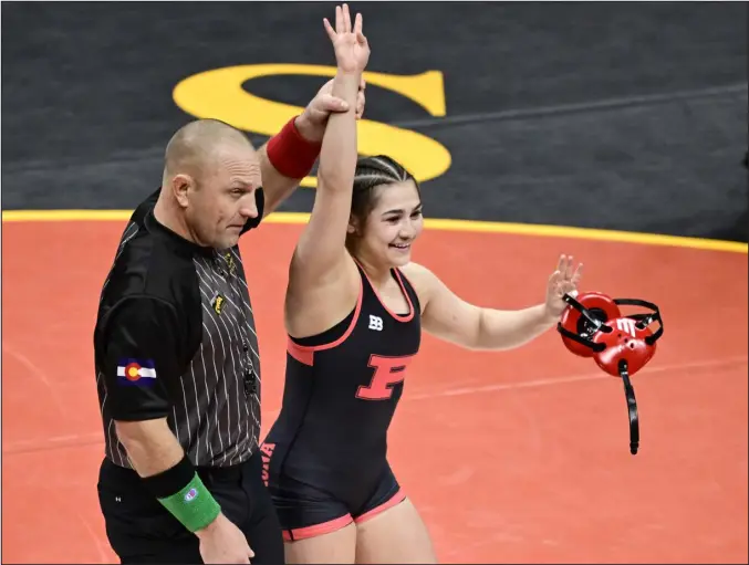  ?? ANDY CROSS — THE DENVER POST ?? Pomona’s Persaeus Gomez celebrates her victory over Cañon City’s Kate Doughty, winning the 130-pound final. Gomez became the first Colorado girls four-time state champion during the CHSAA state wrestling tournament at Ball Arena on Saturday.