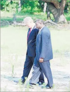  ?? Joe Marquette
Associated Press ?? I N 1996, President Clinton, with the Rev. Terrance Mackey, visited the site in Greeleyvil­le, S. C., where the Mt. Zion AME Church burned down.