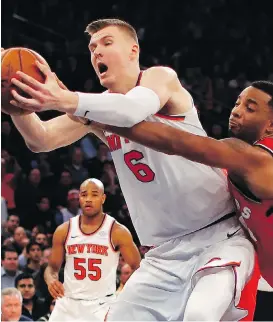  ?? JULIE JACOBSON/THE ASSOCIATED PRESS ?? Raptors forward Norman Powell tries to strip the ball from Kristaps Porzingis of the Knicks Wednesday night in New York. Although the Raptors held Porzingis pretty much in check, the Knicks were 108-100 winners.