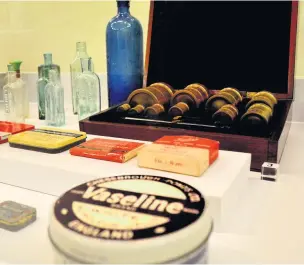  ??  ?? ●●A wooden medicine box and bottles which once contained poisons are among the items on show