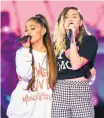  ??  ?? Singers Ariana Grande, left, and Miley Cyrus perform at the One Love Manchester tribute concert Sunday. The show raised over $13 million for the We Love Manchester Emergency Fund.