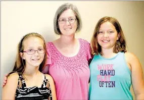  ?? LYNN KUTTER ENTERPRISE-LEADER ?? Prairie Grove Elementary School students Aubrey Ault, left, and Reese Light stand with their teacher Vicki Barker. The girls are semi-finalists in a national competitio­n and Barker encouraged them to submit a project to the contest.