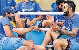  ??  ?? India skipper Virat Kohli shares a joke with teammate Mohammad Shami at the Queen’s Park Oval in Port-of-Spain, Trinidad. AP PHOTO