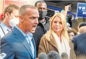  ??  ?? Trump campaign adviser Corey Lewandowsk­i, left, after reporters were shown a court order granting the campaign more access to vote counting operations at the Pennsylvan­ia Convention Centre.