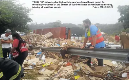  ?? Picture: ROB KNOWLES ?? TRUCK FLIP: A truck piled high with tons of cardboard boxes meant for recycling overturned at the bottom of Southwell Road on Wednesday morning, injuring at least two people