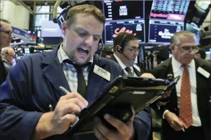  ?? THE ASSOCIATED PRESS ?? Trader Michael Milano works on the floor of the New York Stock Exchange on Thursday.