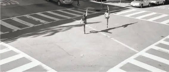  ?? Terez Dean Orr, John Speed Orr and Elliott Morin ?? Smuin dancer Terez Dean Orr and husband John Speed Orr, an alumnus of the company, leap through an empty San Francisco intersecti­on in “Recipe for Disaster.”