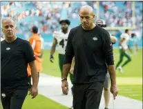  ?? LYNNE SLADKY AND BILL KOSTROUN— THE ASSOCIATED PRESS ?? Jets head coach Robert Saleh, above, leaves the field on Sunday in Miami Gardens, Fla.; Eagles head coach Nick Sirianni, below, reacts to a call earlier this month. Both coaches tested positive for COVID on Tuesday.