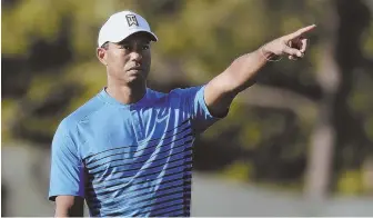  ?? AP PHOTO ?? MAKING HIS POINT: Tiger Woods motions while chipping onto the third green during his U.S. Open practice round yesterday at Shinnecock Hills.