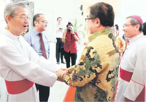  ??  ?? Abang Johari (middle) greets Archbishop Emeritus John Ha (left) while Poh (right) looks on.