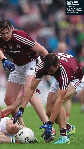  ??  ?? DOWN AND OUT: Galway players surround Jason Doherty of Mayo in Castlebar