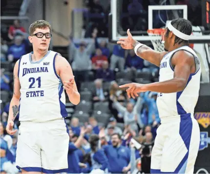  ?? JEFF CURRY/USA TODAY SPORTS ?? Indiana State center Robbie Avila (21) celebrates with guard Ryan Conwell after making a 3-pointer against Northern Iowa during the Missouri Valley Conference Tournament semifinal game on Saturday in St. Louis.