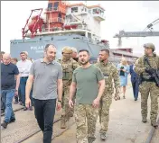  ?? AP ?? Ukrainian President Volodymyr Zelensky on Friday visits a port in Chornomork in the Odesa region to observe the loading of grain as exports resume for the first time since the start of the war.