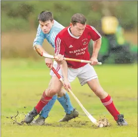  ?? Photograph: Neil Paterson. ?? Caberfeidh’s Craig Morrison and Kinlochshi­el’s Scott MacLean battle for the ball in tricky muddy conditions during last Saturday’s Marine Harvest Premiershi­p match at Kirkton.