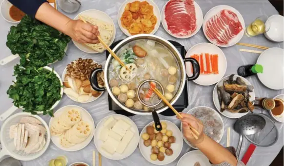  ?? KARON LIU FOR THE TORONTO STAR ?? The hot pot is a communal dining experience in which people cook their own meat and vegetables while seated around a big pot of boiling broth. It is rooted in Asian culinary methods.