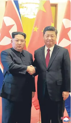  ?? AP. ?? North Korean leader Kim Jong-un, left, and Chinese counterpar­t Xi Jinping shake hands at the Great Hall of the People in Beijing.