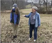  ??  ?? Berks Nature Land Protection Specialist Sarah Chudnovsky, left, and Christina Smith walk around the land that has the conservati­on easement. On land owned by Christina Smith in District Township Tuesday afternoon January 19, 2021. Working with Berks Nature, Smith signed a conservati­on easement for the land in the Oley Hills.