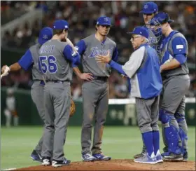  ?? TORU TAKAHASHI — ASSOCIATED PRESS ?? Israel’s manager Jerry Weinstein, wearing glasses, talks to his players on the mound during the sixth inning of their second-round game against Japan at the World Baseball Classic.