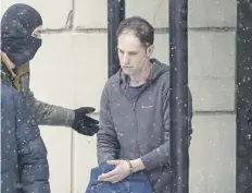  ?? PICTURE: ALEXANDER ZEMLIANICH­ENKO/AP ?? Wall Street Journal reporter Evan Gershkovic­h is escorted from the Lefortovsk­y court after a hearing in Moscow yesterday