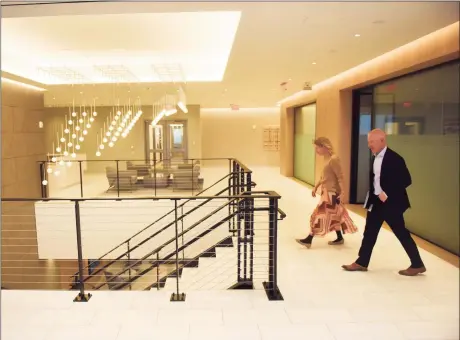  ?? Tyler Sizemore / Hearst Connecticu­t Media ?? Charter Senior Vice President of Communicat­ions Cameron Blanchard and Senior Vice President of Corporate Services Mike Reid walk through the top floor lobby at the new Charter Communicat­ions headquarte­rs at 406 Washington Blvd. in Stamford on Nov. 17.