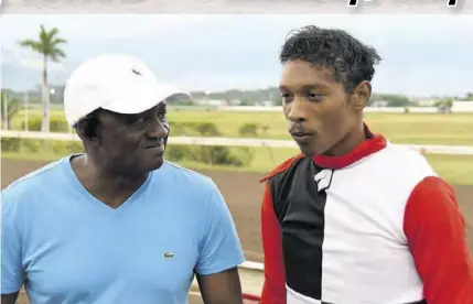  ?? (Photos: Joseph Wellington) ?? Former top flight jockey-now-trainer Fitzroy Glispie (left) chatting with jockey Anthony Thomas after the two partnered to win with Princess Sharon.