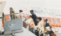  ?? Roger Saint-vincent ?? Asian refugees board an Air Canada charter flight at Entebbe Airport outside Kampala in the fall of 1972.