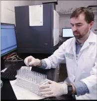  ?? Padraig Brosnan operates a plasma spectromet­er which measure metals. ??