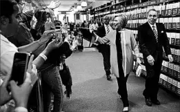  ?? Book party: SETH WENIG/AP ?? Hillary Clinton greets customers as she arrives at a Barnes and Noble store in New York on Tuesday to sign copies of her campaign memoir “What Happened.”