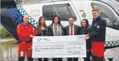  ??  ?? Dr Antony Hudson and Critical Care Paramedic Adam Ormrod receive a cheque from Martin Tolhurst staff Dana Gray, Victoria Aked, Mark Price and Rebecca Young