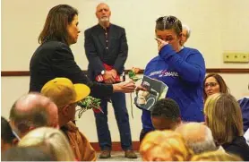  ?? Christian Abraham/Hearst Connecticu­t Media file photo ?? Laura Slinsky, whose son Shane was murdered in 2016, wipes away a tear as Michele Voigt, with Moms Demand Action for Gun Sense in America, hands her an orange rose during an event in 2020. Nearly seven years after Shane was found shot to death in Bridgeport his former best friend has pleaded guilty in connection with the crime.