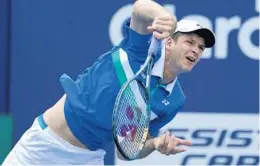  ?? LYNNE SLADKY/AP ?? Hubert Hurkacz follows through on a serve to Stefanos Tsitsipas during the quarterfin­als of the Miami Open tennis tournament on Thursday in Miami Gardens. Hurkacz advanced with a 2-6, 6-3, 6-4 victory.