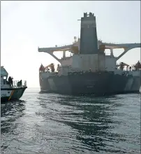  ?? Grace 1 Reuters ?? ANCHORED: A Spanish Civil Guard ship sails next to Iranian oil tanker as it sits anchored in the Strait of Gibraltar. —