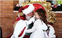  ?? Gazette file photo ?? ■ Adaleigh Lummus sits on Santa Claus’ lap in front of the Perot Theatre during TRAHC's first Holiday Traditions event in 2018. TRAHC plans to continue the annual holiday festivitie­s this year.