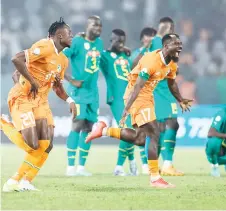  ?? — AFP photo ?? Ivory Coast’s Christian Kouame (left) and Serge Aurier celebrate after the victory at the end of the last 16 match against Senegal.