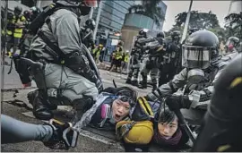  ?? Marcus Yam Los Angeles Times ?? POLICE detain protesters in Hong Kong on Sept. 29, 2019. Many jailed protesters, serving sentences of three to four years, have been released in recent months.