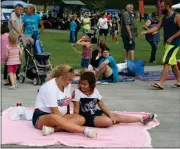  ?? Diane Wagner / Rome News-Tribune ?? Karen Clark (left) of Shannon talks with her granddaugh­ter Lauren Lenon, 8, on their blanket set up in front of the stage Tuesday evening at the Harbin Clinic Splash Bash and Patriotic Party in Ridge Ferry Park.