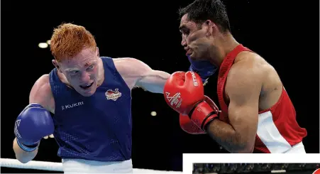  ?? Photos: EDDIE KEOGH/GETTY IMAGES ?? EXTRA GEARS: England’s Aaron Bowen [left] lasts the course better than Indian Ashish Kumar,earning a 4-1 decision. Below: Lewis Richardson of England [right] fought back hard against Guernsey man Billy Le Poullain