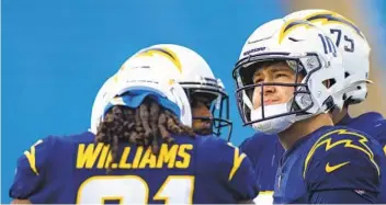  ?? BRETT CARLSEN AP ?? Chargers’ Justin Herbert (10) hopes playing for each another will provide motivation to finish season strong.