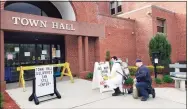  ?? Contribute­d photo ?? The entrance to Cromwell Town Hall is disinfecte­d earlier this year.