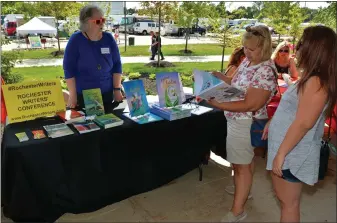  ?? PHOTO COURTESY OF MICHAEL DWYER ?? Rochester Writers displaying several of their member’s books at SterlingFe­st 2019.