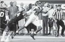  ?? Ralph Freso Associated Press ?? DEONTAY BURNETT of USC hauls in a touchdown pass Saturday despite tight defensive pressure from ASU’s Chase Lucas.