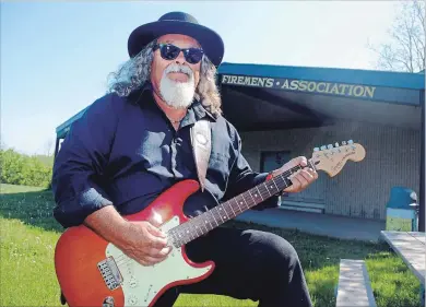  ?? PAUL FORSYTH METROLAND ?? Paul Lemire, co-organizer of the Day of 1,000 Musicians event planned for Firemen’s Park in Niagara Falls on July 21, holds one of his guitars at the park on Dorchester
Road in front of the performanc­e stage.