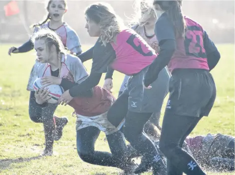  ?? JEREMY FRASER/CAPE BRETON POST ?? Sheridee Etheridge of the Riverview Rugrats, left, carries the ball as she’s tackled by Kelsie MacDonald of the Glace Bay Panthers during the Highland region girls’ rugby championsh­ip game Wednesday at Hub Field in Glace Bay. Riverview won the game 7-5 and will play in the provincial championsh­ip tournament in the coming weeks.