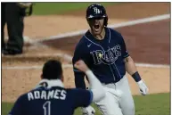  ?? (AP/Jae C. Hong) ?? Michael Brosseau celebrates with Willy Adames after he hit a solo home run during the eighth inning to give the Tampa Bay Rays the lead in a 2-1 victory over the New York Yankees on Friday night in the American League division series.