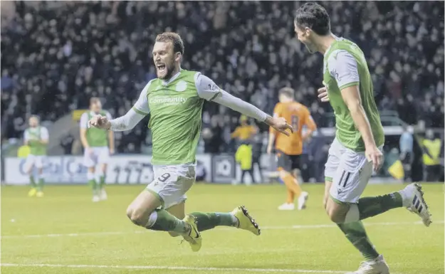  ??  ?? 0 Hibs’ hat-trick hero Christian Doidge launches himself into a knee slide to celebrate his first goal in last night’s 4-2 Scottish Cup win over Dundee United at Easter Road.