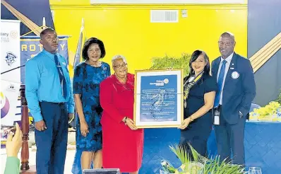  ?? CONTRIBUTE­D PHOTOS ?? At left Rotary Past Assistant Governor Marie Powell and Club President Melissa Anderson (right) present the Vocational Service Award to Captain (Naval) Judy-Ann Neil (centre) who won in the outstandin­g individual category.