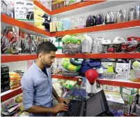  ?? Reuters ?? A shopkeeper works on laptop at his online shop in Kabul.—