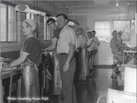  ?? COURTESY — BILL CUTCHER ?? Owner of Kishman Fish, Ray Full, in the fish cleaning kitchen, 1960.