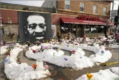  ?? Jim Mone/Associated Press ?? A mural of George Floyd is seen in George Floyd Square in Minneapoli­s. The city of Minneapoli­s on Friday agreed to pay $27 million to settle a civil lawsuit from Floyd's family over the Black man's death in police custody, as jury selection continued in former Officer Chauvin’s murder trial.