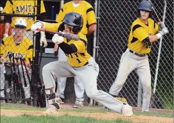  ?? Dave Phillips / Hearst Connecticu­t Media ?? Amity centerfiel­der A.J. Soldra bunts for a base hit in the sixth inning on May 23.